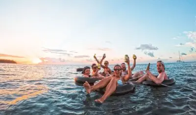 A group of friends floating in the water on inflatable tubes