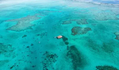 Aerial view of the ocean showing coral reefs and the Clear waters of Fiji