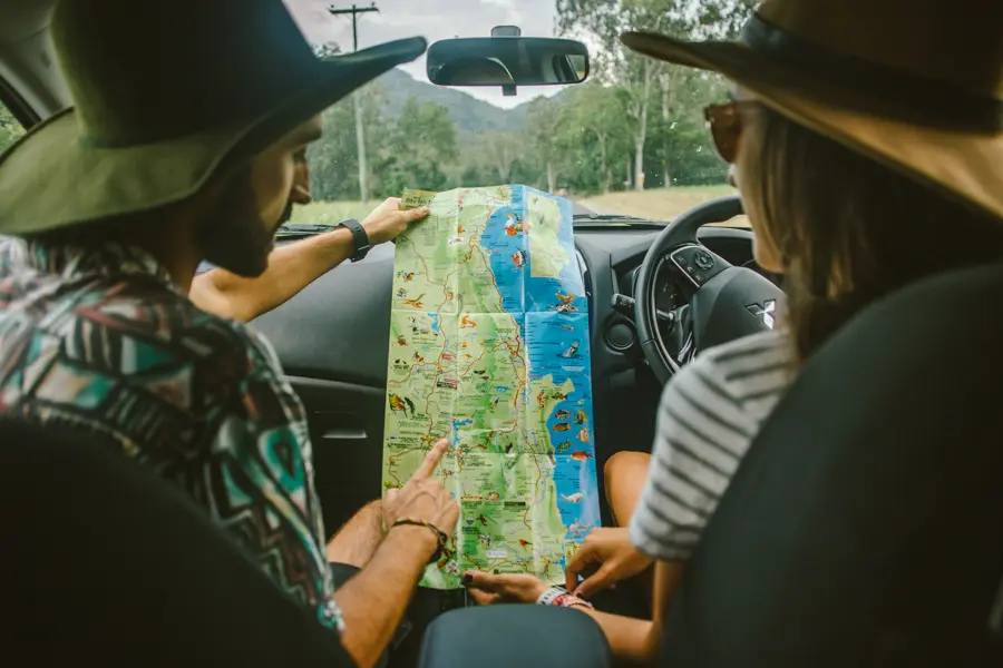 people looking at a map in the car on australias east coast
