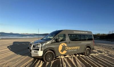 a black van parked on a beach