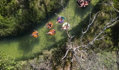 backpackers exploring K'gari on inflatables on a river Peterpans