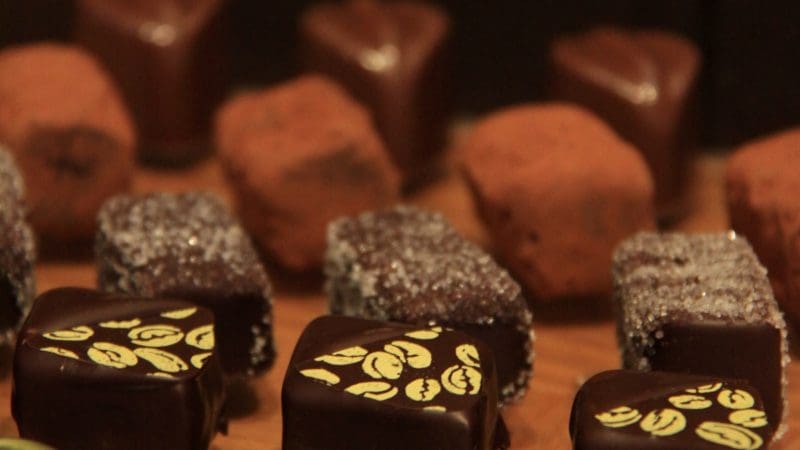 Premium selection of gourmet chocolates and truffles inspired by Yarra Valley Grazing Tour, beautifully displayed on rustic wood.