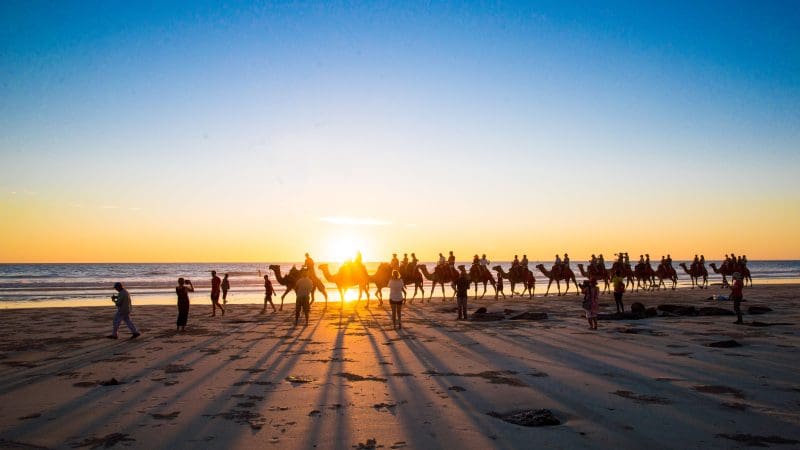 Experience a breathtaking sunset camel ride casting dramatic shadows on the 10 Day Broome to Darwin Kimberley Off Road Adventure Tour.
