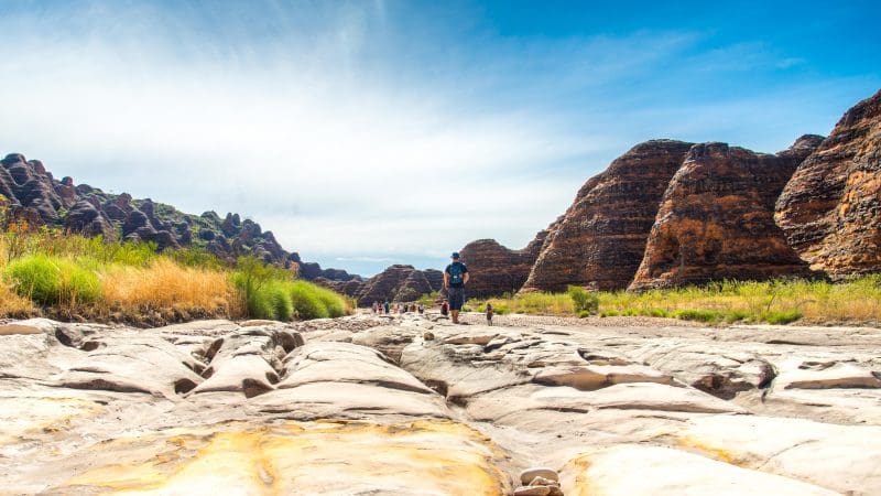 Adventurer navigates a scenic rocky riverbed on a 10-Day Broome to Darwin Kimberley Off-Road Adventure Tour in Australia.