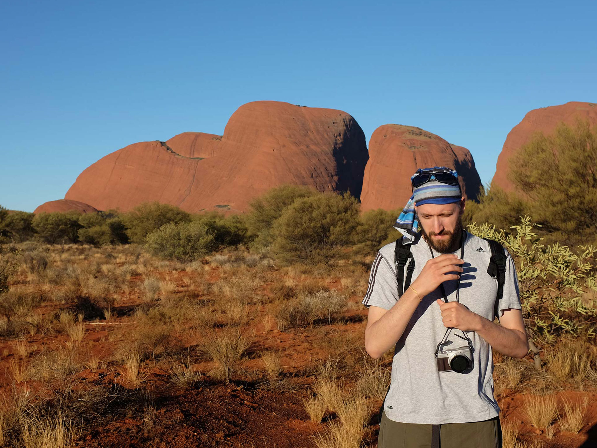 A photographer documents the 3 Day Uluru Rock The Centre Tour from Yulara to Alice Springs in the Australian desert landscape.