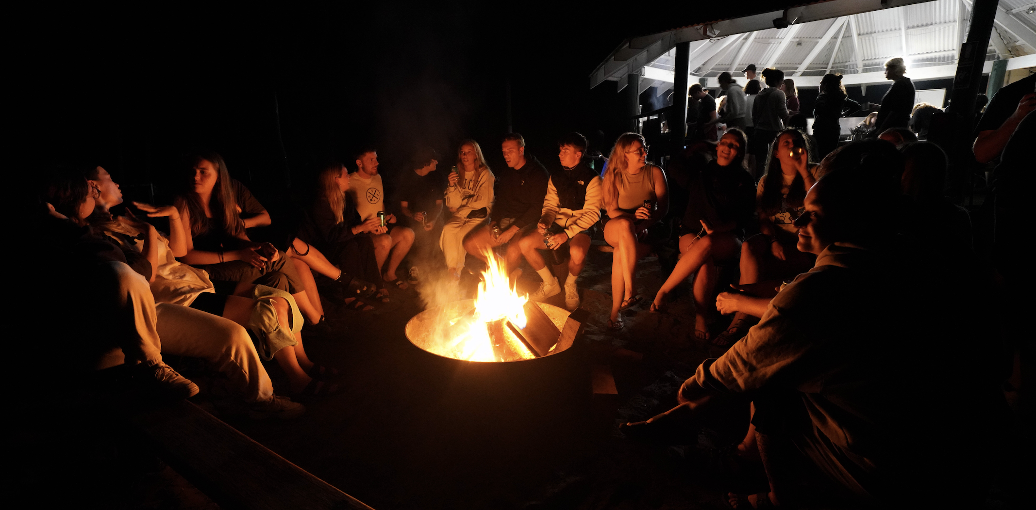 A group of solo travellers around the campfire on Dingos K'gari 3 day 2 night 