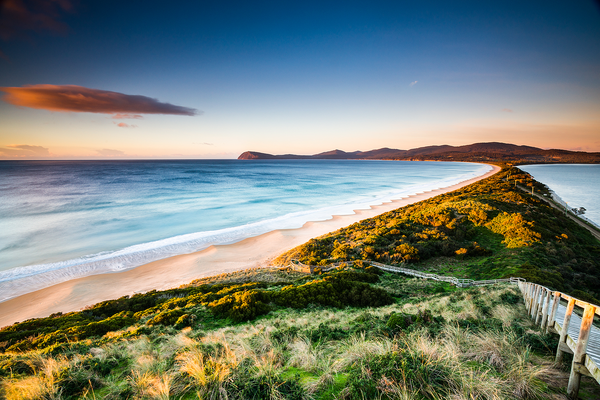 Scenic wooden stairs descend to Bruny Island’s iconic sandy isthmus, a must-see attraction on top-rated Tassie Tours Tasmania day trips.