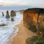 Spectacular sunset illuminates the Twelve Apostles’ iconic sea stacks and rugged cliffs on a Go West Tours Great Ocean Road day trip.