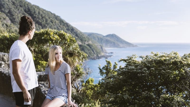 Two travellers admire breathtaking coastal scenery on the 3 Day Great Ocean Road and Grampians Explorer tour from Melbourne.