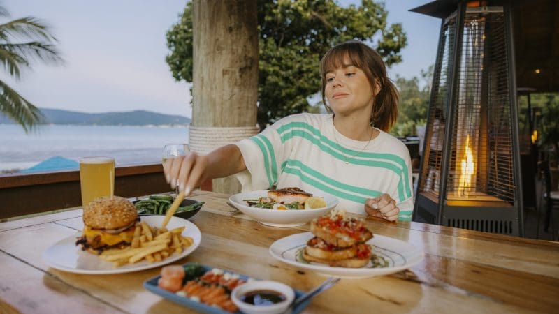woman having lunch at beach bar