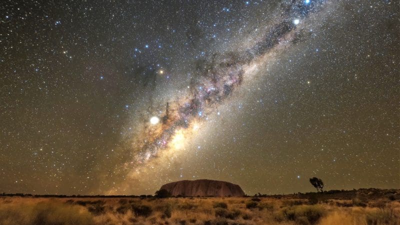 Breathtaking Milky Way over Uluru at night during a 4-day Uluru, Kata Tjuta, and Kings Canyon tour from Yulara to Alice Springs.