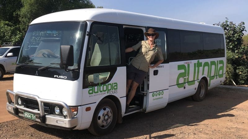 Traveller in a hat and sunglasses by Autopia Tours minibus on Darwin’s Half-Day Jumping Crocodile Tour, ready for adventure.