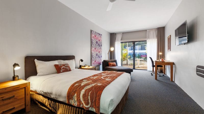 Spacious modern hotel room with private balcony overlooking scenic views, ideal accommodation for 4 Day Kakadu Katherine Gorge Tour.