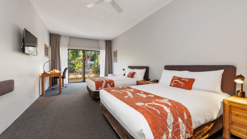 Spacious hotel room with twin beds, stylish modern décor, and lush garden views—ideal relaxation after Kakadu Katherine Gorge tours.