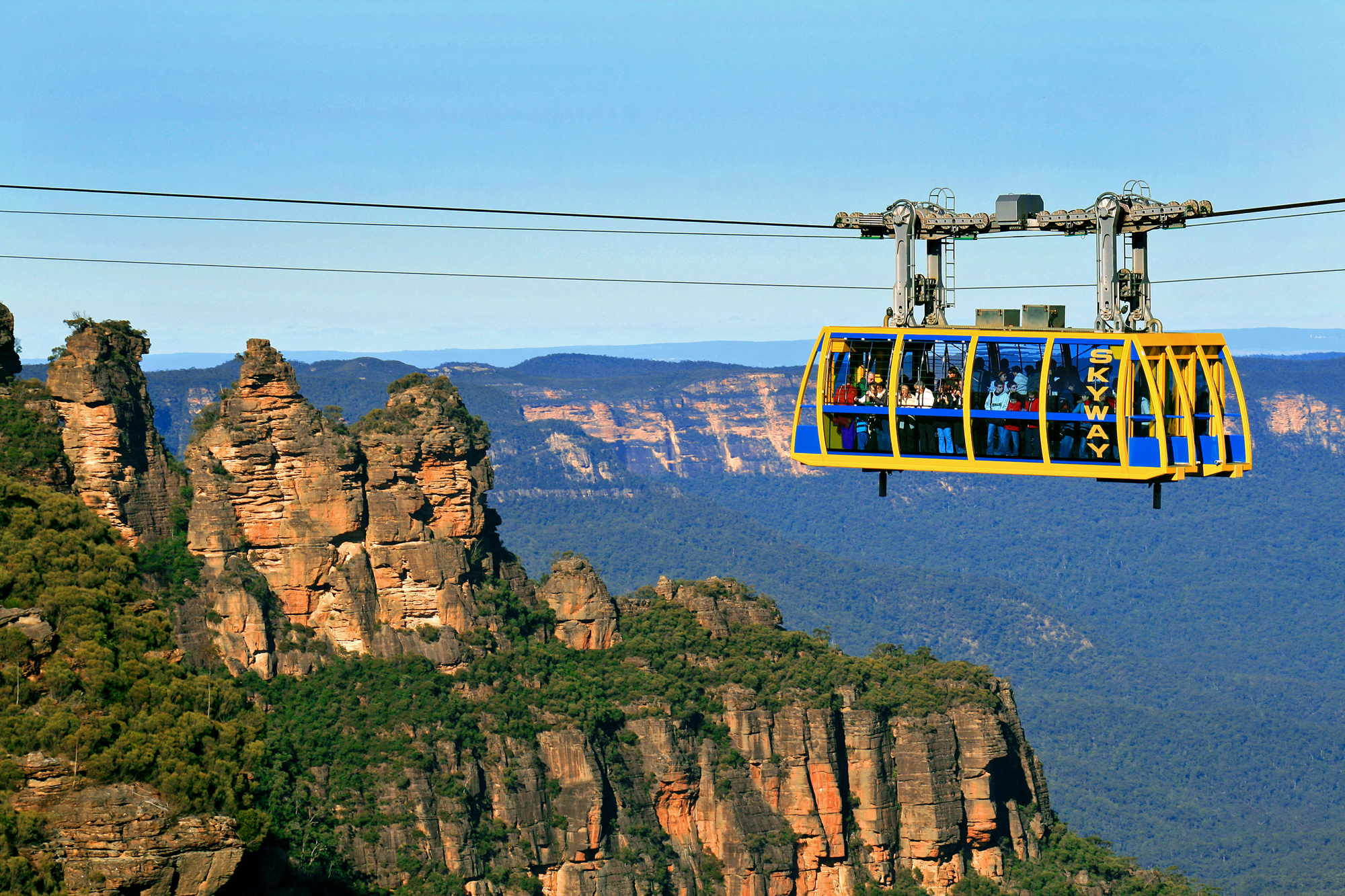Experience breath-taking views as a yellow and blue cable car soars above the stunning Blue Mountains canyon on a signature day tour.