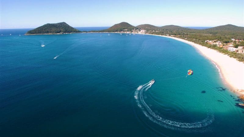 Stunning aerial view of Port Stephens’ turquoise bay, ideal for an unforgettable 1 Day Dolphin Watching with Colourful Collective Travel.