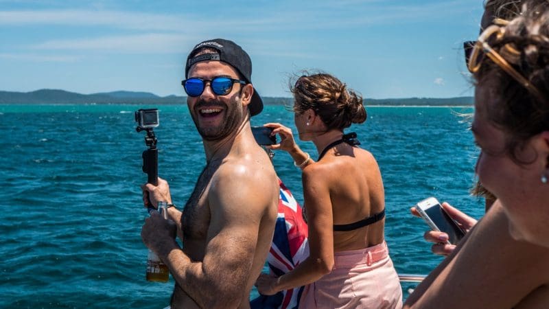 Happy group of three on a 1 Day Whale Watching Port Stephens tour with Colourful Collective Travel, enjoying scenic ocean views.