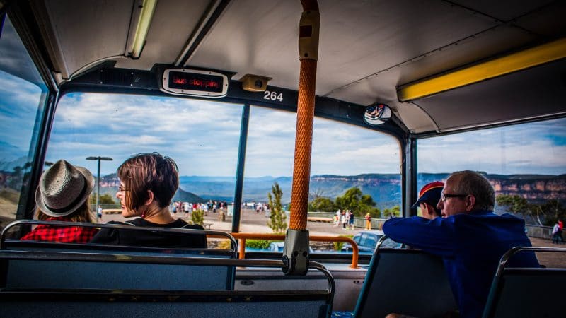 Interior of a Lyrebird Pass Hop On Hop Off bus with passengers enjoying panoramic views of Scenic World’s stunning Blue Mountains.