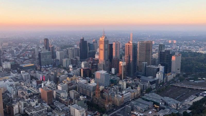 Stunning aerial view of Melbourne skyline at sunset, showcasing iconic landmarks for the ultimate Melbourne adventure experience.