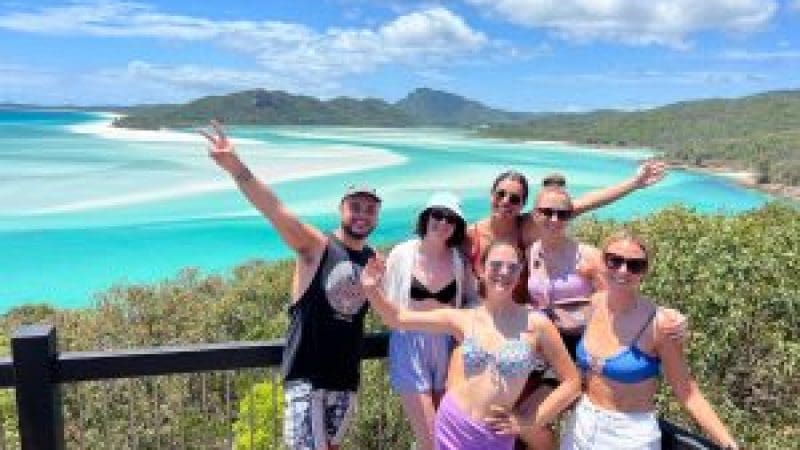 a group of friends at hill inlet overlooking Whithaven Beach