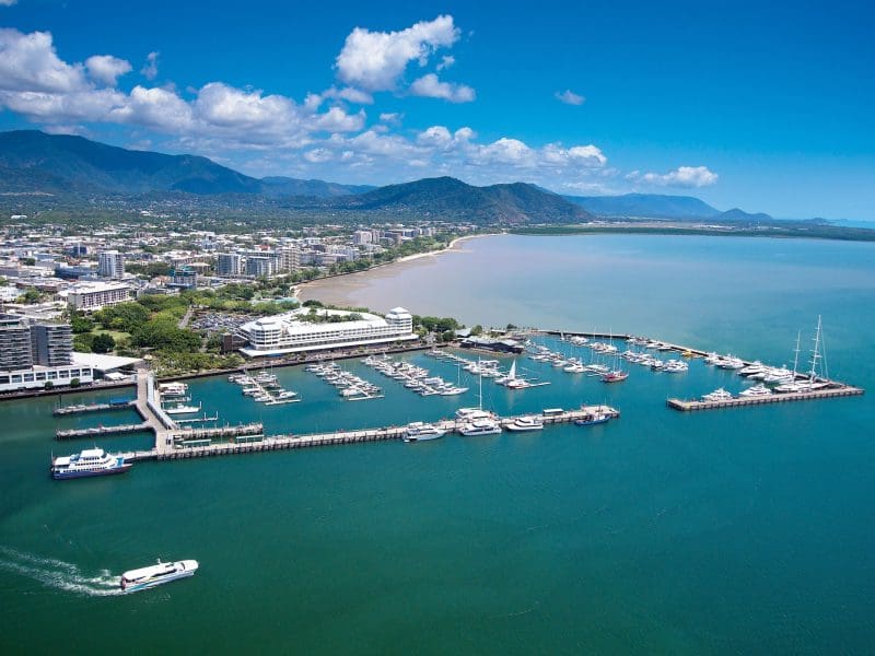 Stunning aerial view of marina with boats and city skyline on 14 Day Sydney to Cairns, Fraser Island & Whitsundays Comfort Tour.