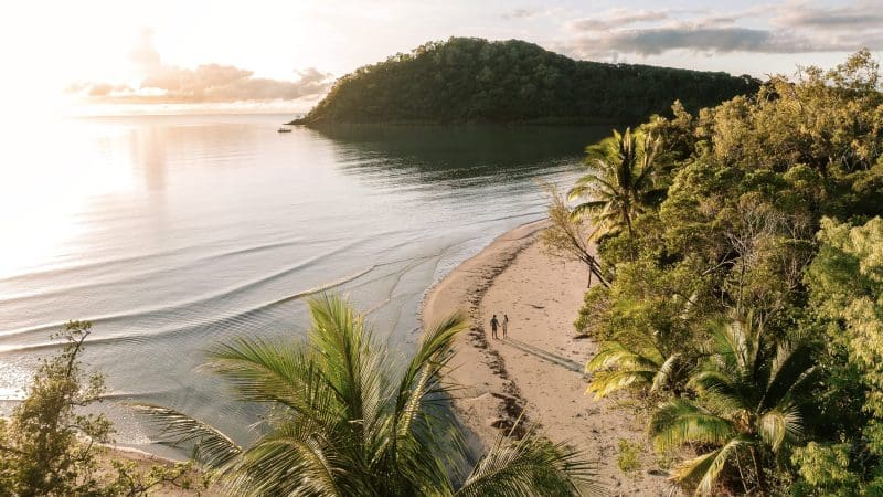 Breathtaking aerial view of a golden tropical beach at sunset, ideal for a 16-Day East Coast Australia Tour from Sydney.
