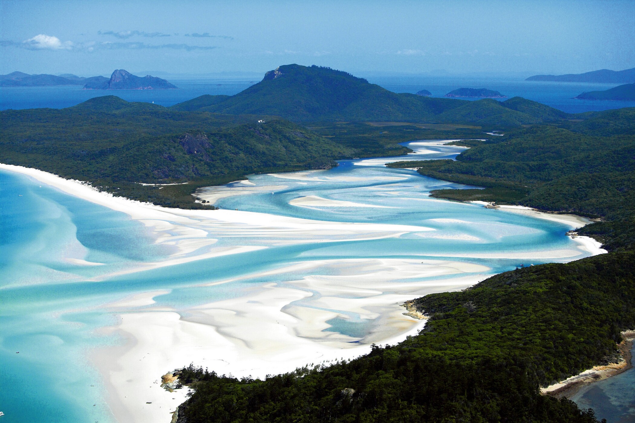 Spectacular aerial view of vibrant turquoise waters weaving through pristine white sands on a Sydney to Cairns, Fraser Island tour.