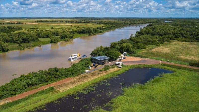 Stunning aerial view of a river, boats, and dock, capturing the excitement of a Kakadu Wilderness Escape and Crocodile Cruise adventure.