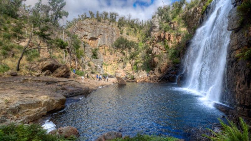 Experience a breathtaking waterfall cascading into a rocky pool in the Grampians—ideal for your unforgettable 1 Day Eco Wilderness Escape.