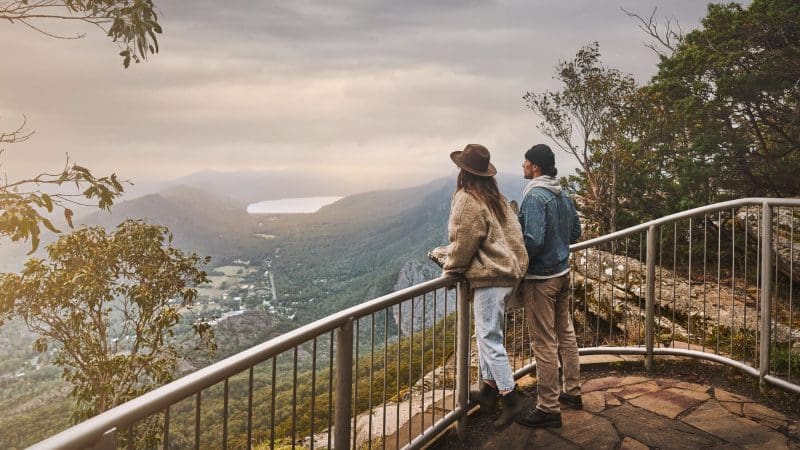 Two adventurers enjoy breathtaking mountain and valley river vistas on a 1 Day Grampians Eco Wilderness Escape in Australia.