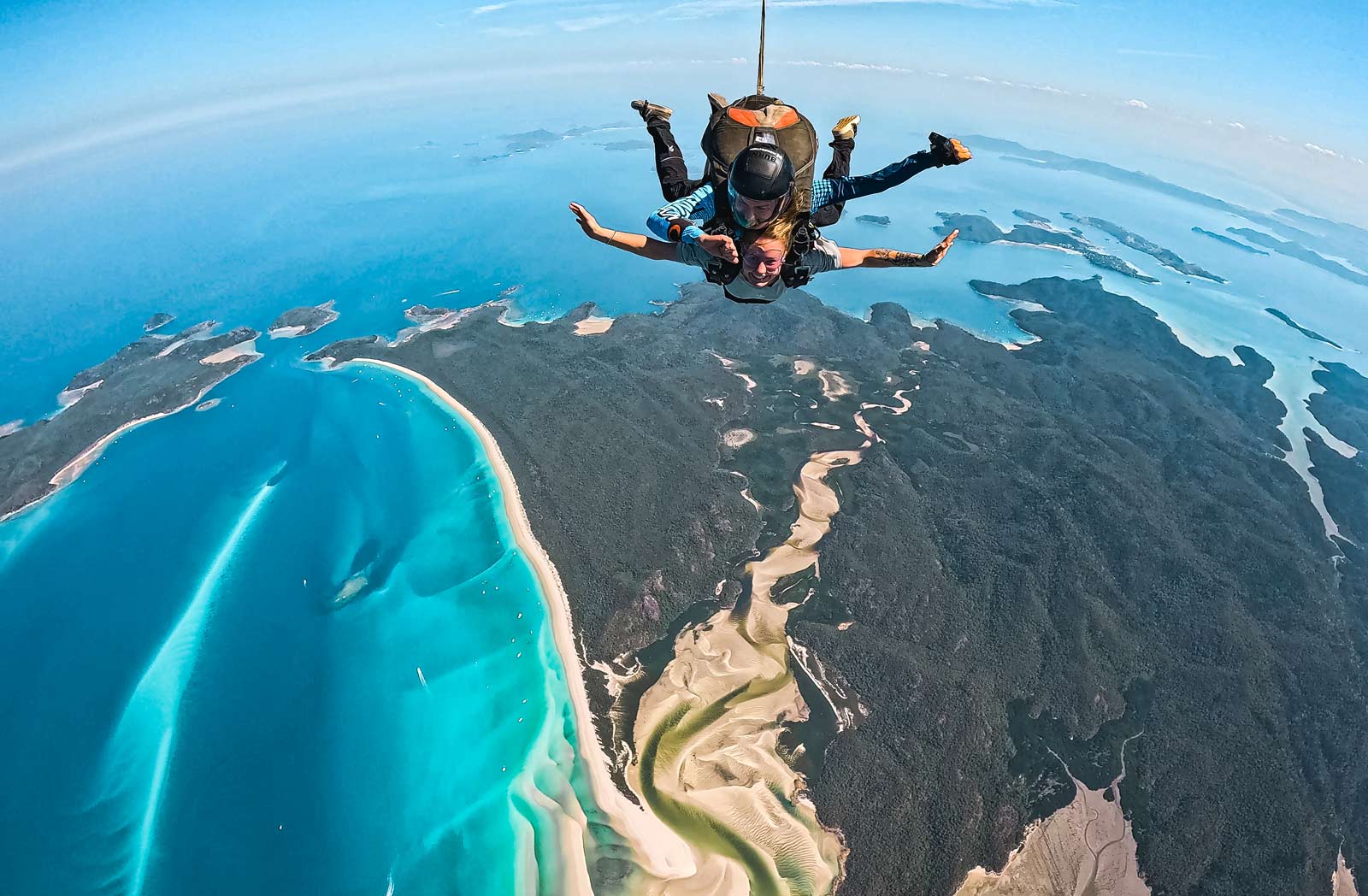 Experience an epic tandem skydive over Whitehaven Beach, captured in HD video and photos—fly above turquoise waters, sandy shores, lush islands.