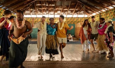 Image of travellers dancing with locals in Fiji during their village tour to experience local cultures and ceremonies