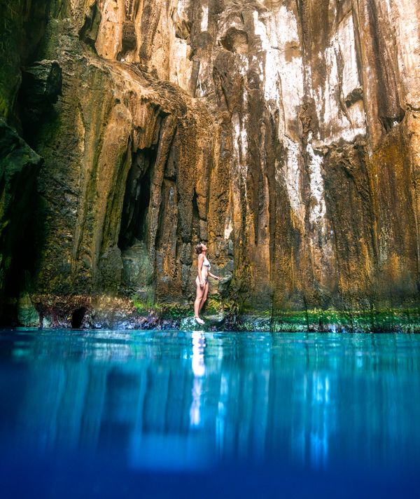 Cave exploring in Fiji with peterpans Woman standing in the Sawa I Lau Caves in the Blue lagoon region in fiji